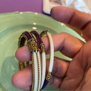 3 Gold tone metal bangles, purple and white resin/enamel.